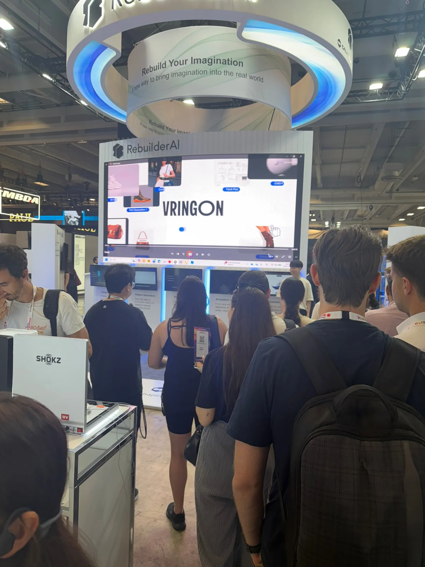 Visitors watching a screen in front of a VivaTech booth
